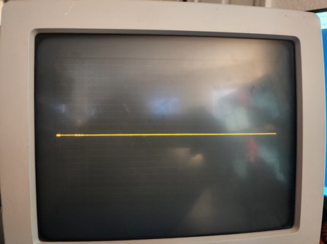 A CRT with a thin orange line horizontally down the middle, with some spots that are brighter than others. The rest of the screen is dark