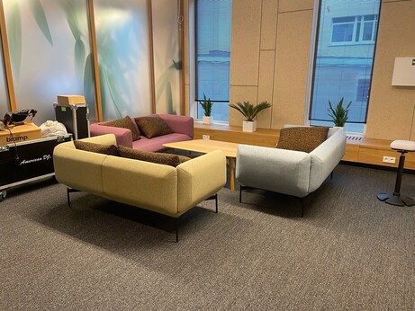 A sofa corner with some plants (fake)