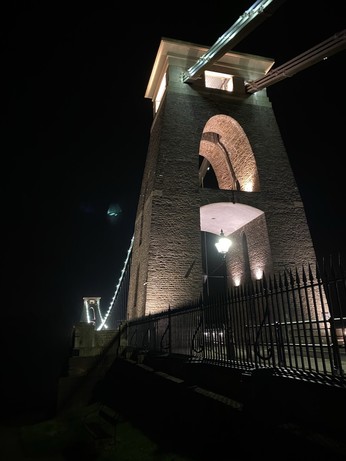 The east pillar of the Clifton Suspension Bridge. There is some detail visible around it, but it is mostly shadow. 