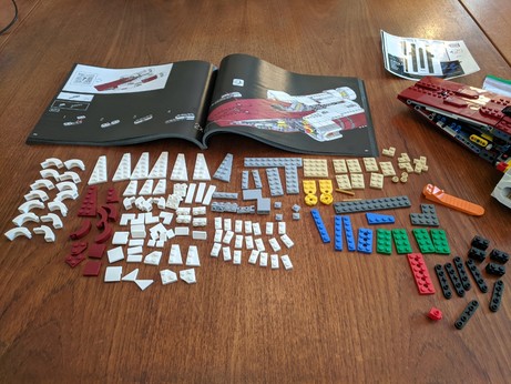 I am running out of ways to say that there a big pile of Lego bricks and pieces on the table.