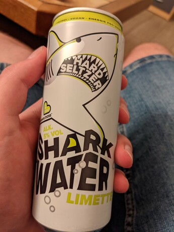 a can of hard seltzer with a shark on it, labeled "Shark Water"