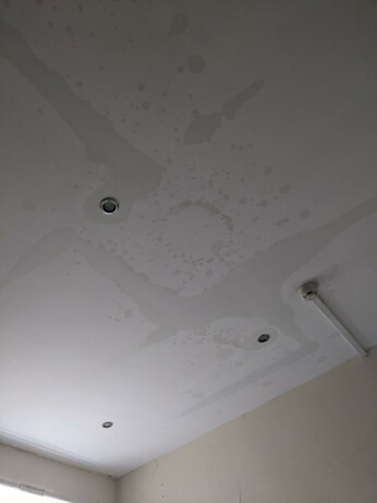 A white ceiling with water damage