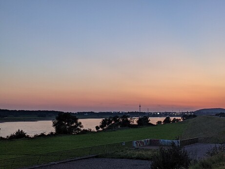 the Rhine with a skyline behind it, with the radio tower in Moers visible