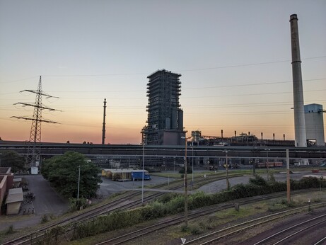 a bunch of steelmaking-related industry with a sunset behind it