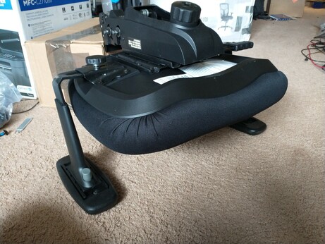 A partially put together office chair that is upsidedown.