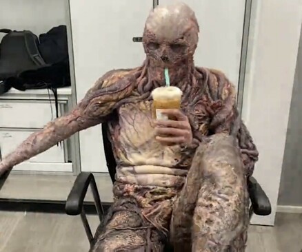 Vecna sipping on a coffee in a make-up chair behind the scenes of Stranger Things.