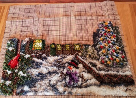 Current rug progress showing tree, snowman, qnd cardinal