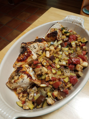 roasted chicken breasts with browned skin and a medley of eggplant, tomato, and zucchini roasted with the chicken