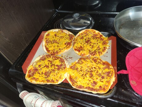 Some naan bread pizzas fresh out of the oven