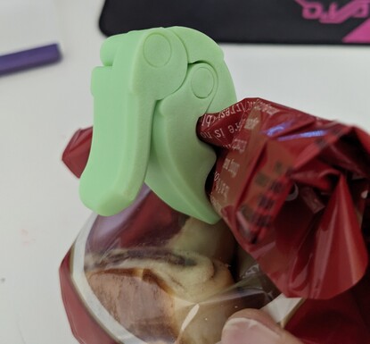 a chunky zig-zaggy clip holding a bag of snacks shut
