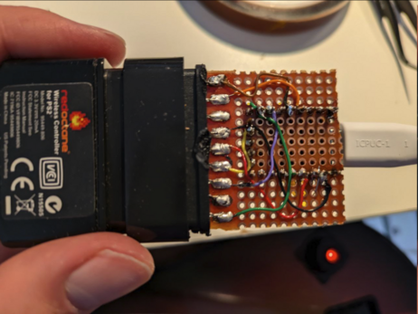 It's a little rp2040 board with USB-C and a Guitar Hero wireless adapter on the other end