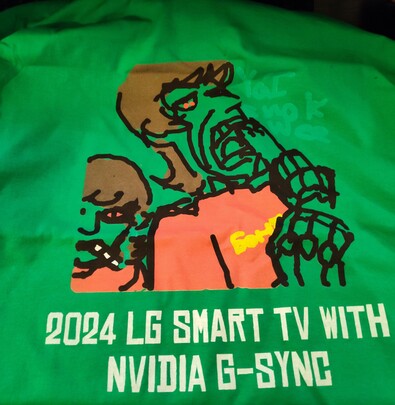Flash photo of a green t-shirt with an illustration of a humanoid robot holding a bong as if they were going to take a hit, but they are biting the rim, cracks appearing. The robot is wearing a shirt that says "бонг" ("bong"), and has bloodshot eyes. To the left is the same robot, facing the camera and smoking a joint. Text next to the robot's head says "Ya I smok wee" 
Text below the illustration says "2024 LG Smart TV With Nvidia G-Sync
