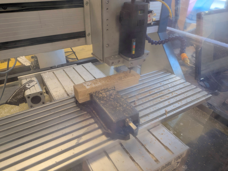 a cnc machine going to town on a block of oak